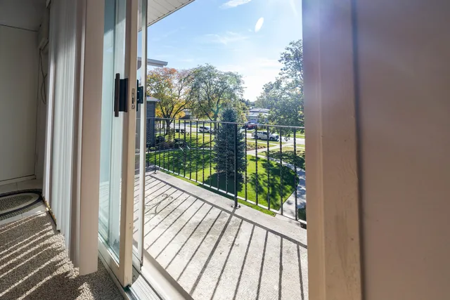 a view of a balcony with wooden floor