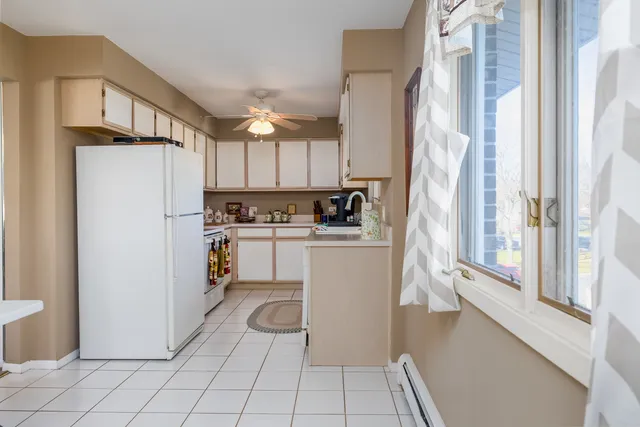 a kitchen with a refrigerator a stove a washer and dryer