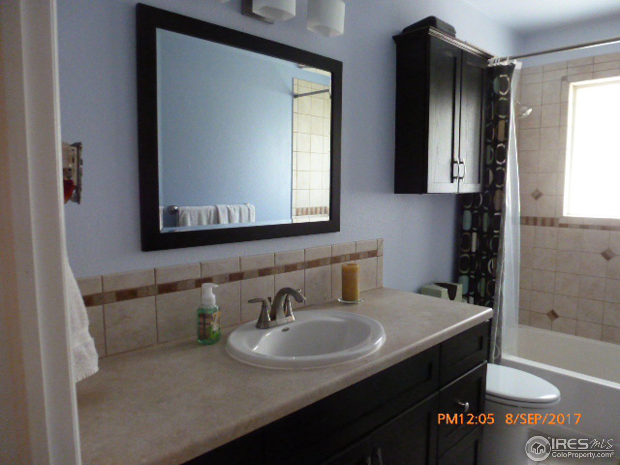 3317 West 5th St Road Greeley, CO 80634 - Photo 18 of 20 a bathroom with a sink and a mirror