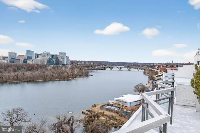 a view of a terrace with lawn chairs