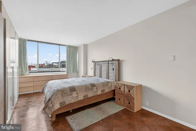 a bedroom with a bed and window