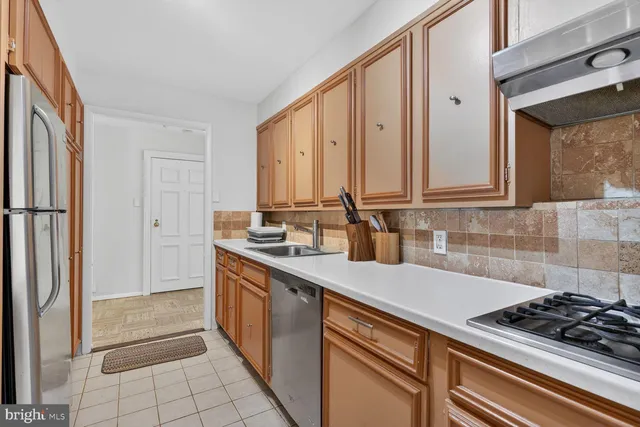 a kitchen with stainless steel appliances a stove and a refrigerator