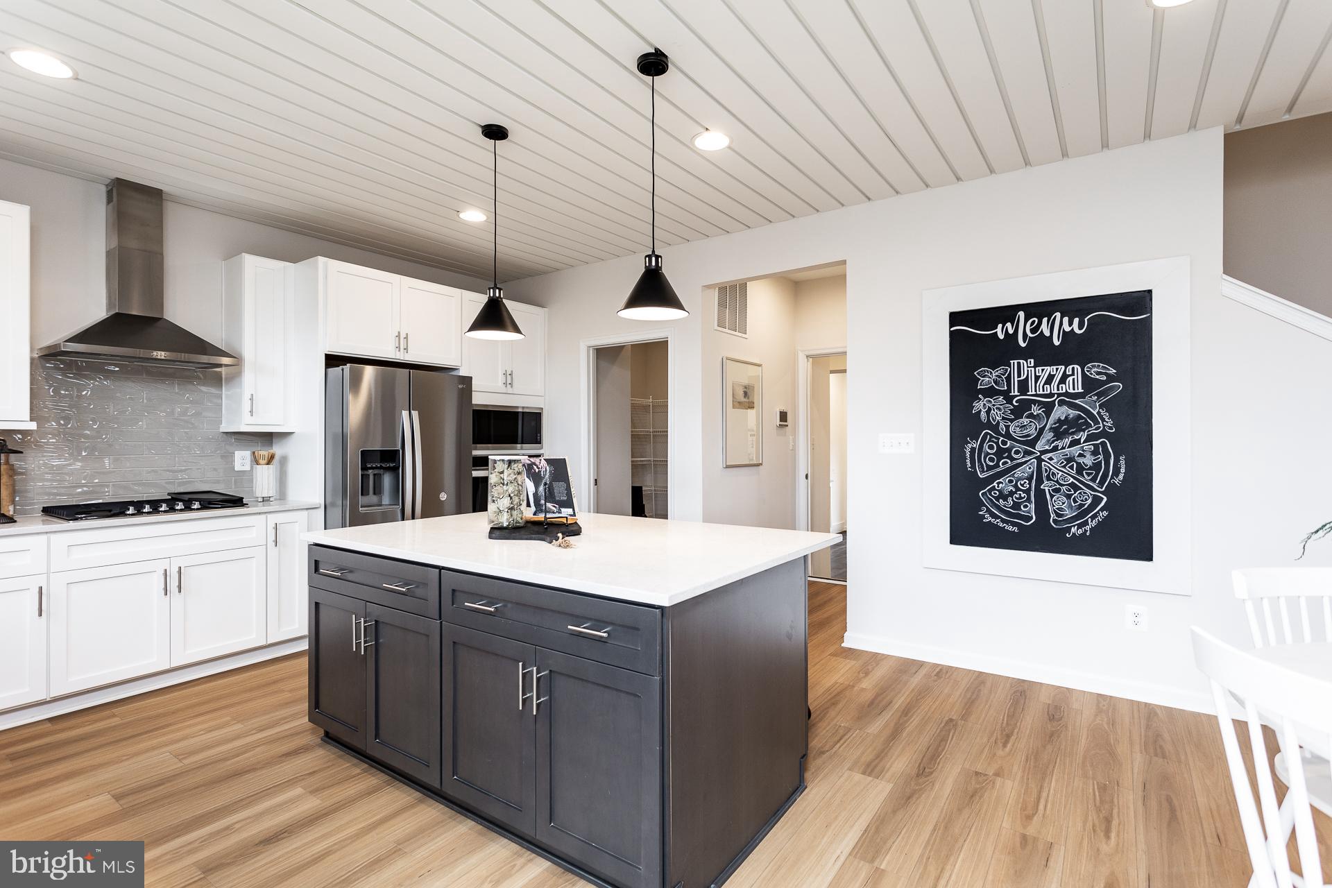 514 Benjamin Drive Hanover, PA 17331 - Photo 7 of 29 a kitchen with stainless steel appliances kitchen island granite countertop a sink stove and refrigerator