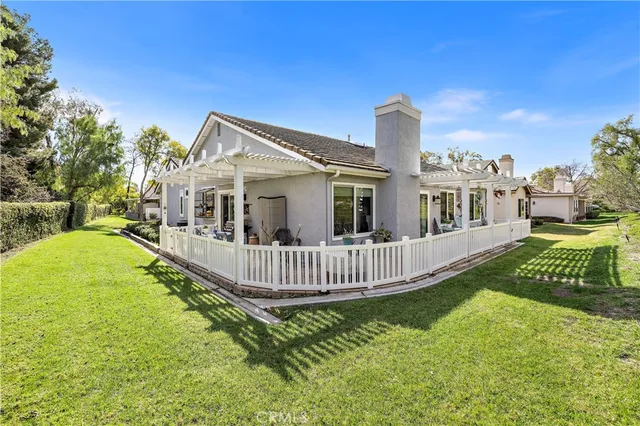 a view of a house with a yard deck and a garden