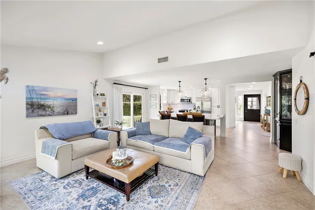 a living room with furniture couches and a table