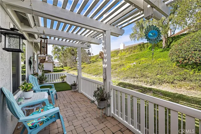 a view of a chairs and table in the balcony
