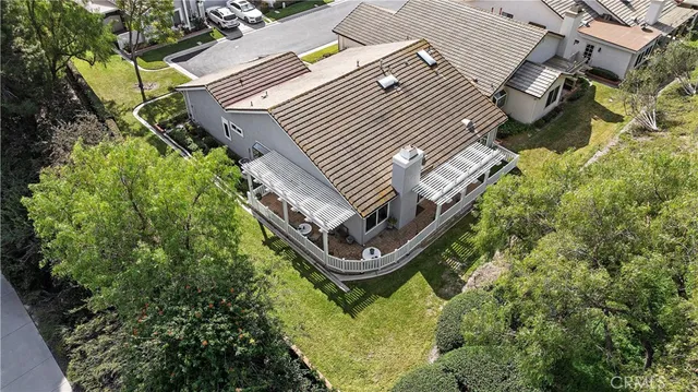 an aerial view of a house with a yard