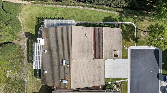 an aerial view of a house with a yard
