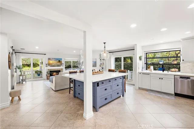 a large white kitchen with cabinets