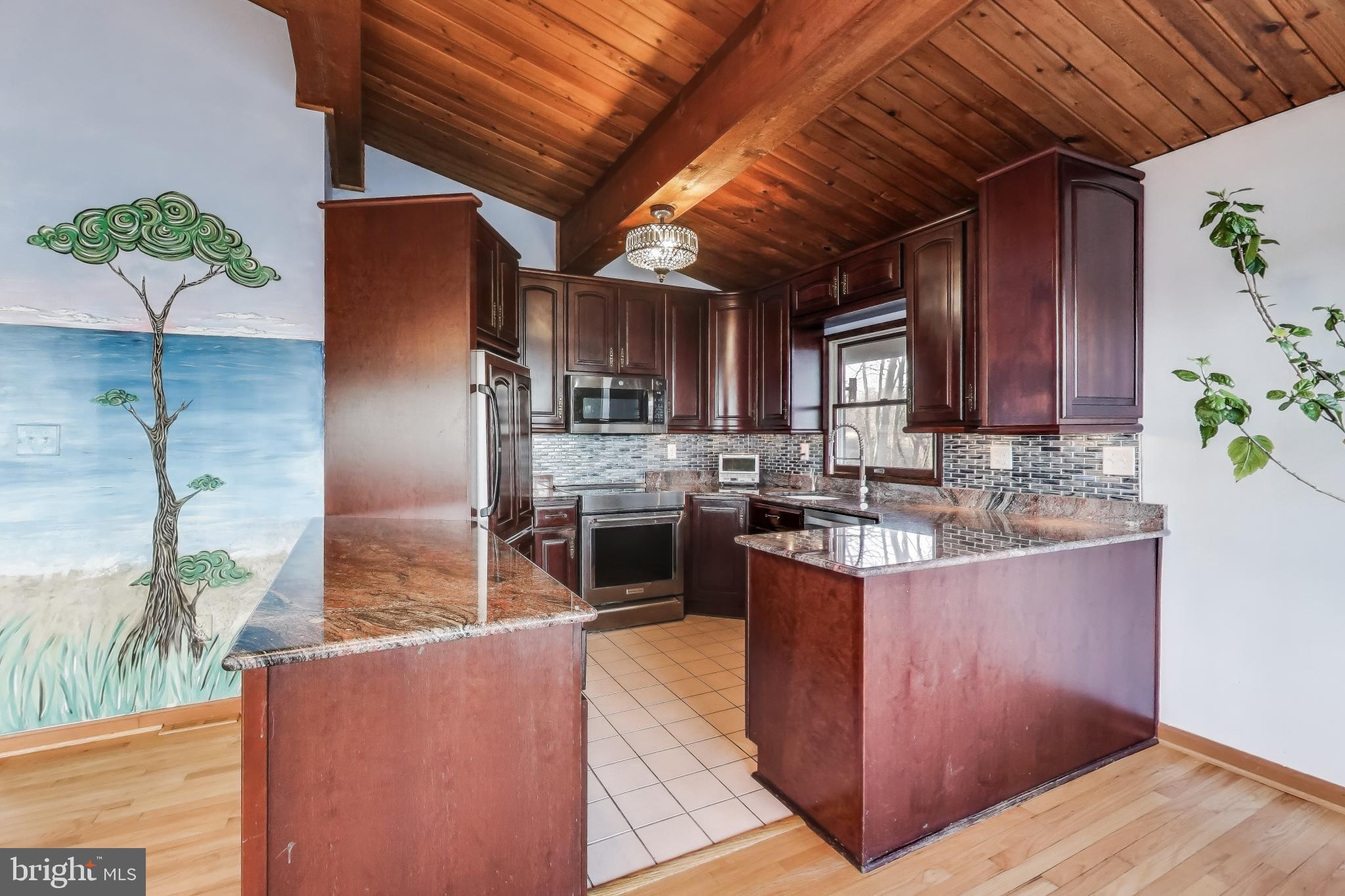 418 Point Mary Circle Tracys Landing, MD 20779 - Photo 18 of 59 a kitchen with stainless steel appliances granite countertop a sink stove and refrigerator