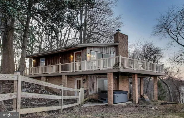 a front view of a house with a trees