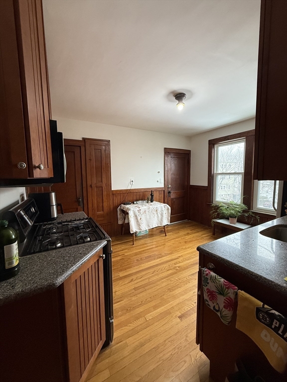 7 View S Avenue, Unit 3 Boston, MA 02130 - Photo 2 of 14 a kitchen with stainless steel appliances granite countertop a stove a sink and a refrigerator