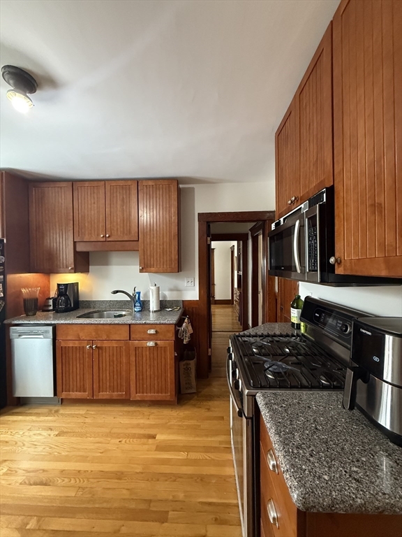 7 View S Avenue, Unit 3 Boston, MA 02130 - Photo 3 of 14 a kitchen with stainless steel appliances granite countertop a stove a sink dishwasher and a refrigerator