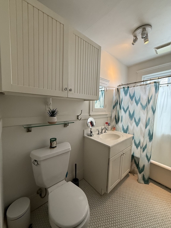 7 View S Avenue, Unit 3 Boston, MA 02130 - Photo 9 of 14 a white toilet sitting next to a bathroom sink