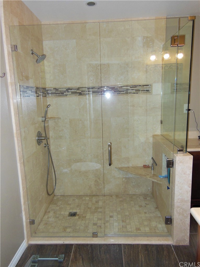 4731 Whipple Road Riverside, CA 92506 - Photo 21 of 66 PRIMARY BATHROOM. This Bathroom's Remodel greatly enlarged the existing Shower Enclosure, added Seamless Glass, Walk/Roll-in Access, a Hand-held Sprayer, and, added a very remarkable, Cal Faucets $$$ Shower Valve.