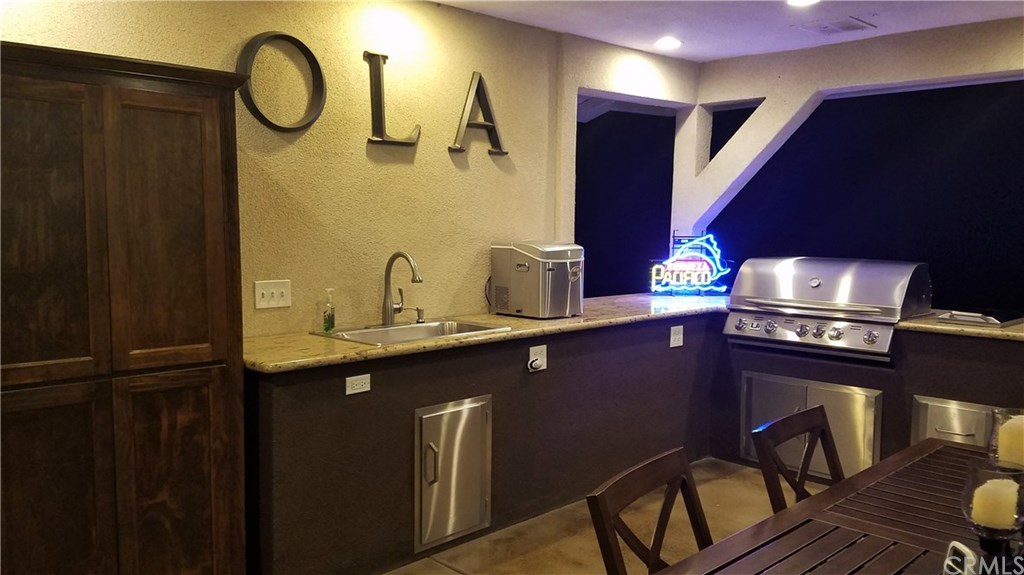 4731 Whipple Road Riverside, CA 92506 - Photo 48 of 66 The LOGGIA! This shot defines the Outdoor Kitchen! NOTE: Custom, Upright Cabinet for Storage of Pots, Pans, Plates, Outdoor Glassware, Silverwares, Cutting Boards, etc. Photo also shows the Large, Undivided Sink, Ice Maker, URBAN ISLAND/COSTO BBQ-OVEN w/Two Side Burners, and, Storage Areas & Drawers!