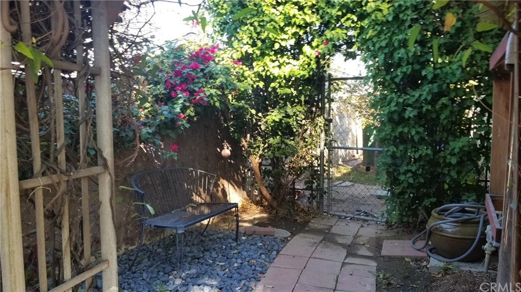 4731 Whipple Road Riverside, CA 92506 - Photo 63 of 66 Sideyard - This area is known as "The Park!" Through the gate is a Plum Tree & a White Babcock Peach, and, the Composter (also included). On the right is the TAKAGI Tankless Water Heater, and the , the HALO 5 Whole House Water Filtration System (if you've never has one of these, You are going to luv it!)