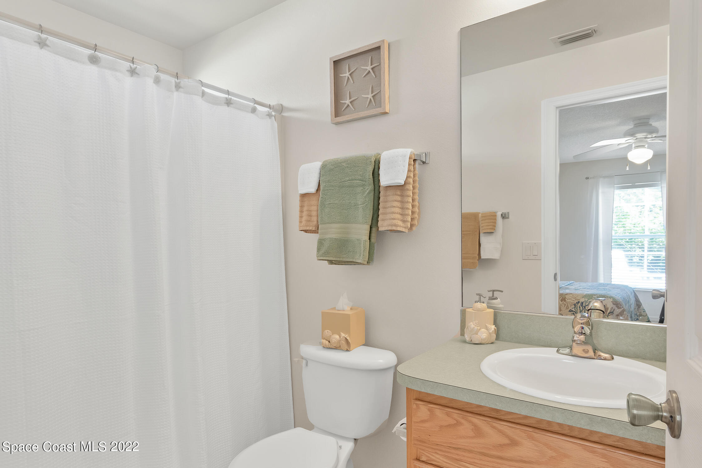 382 Benchor Street Sebastian, FL 32958 - Photo 11 of 34 a bathroom with a sink mirror vanity and toilet
