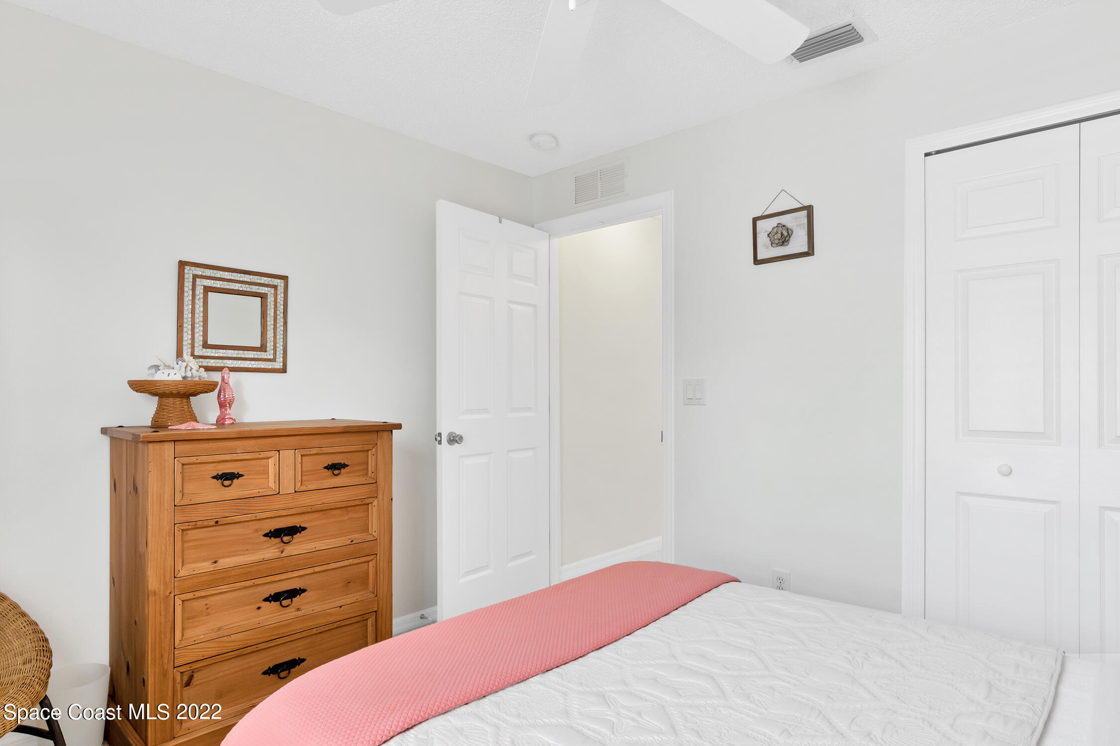 382 Benchor Street Sebastian, FL 32958 - Photo 13 of 34 a bedroom with a bed and a dresser