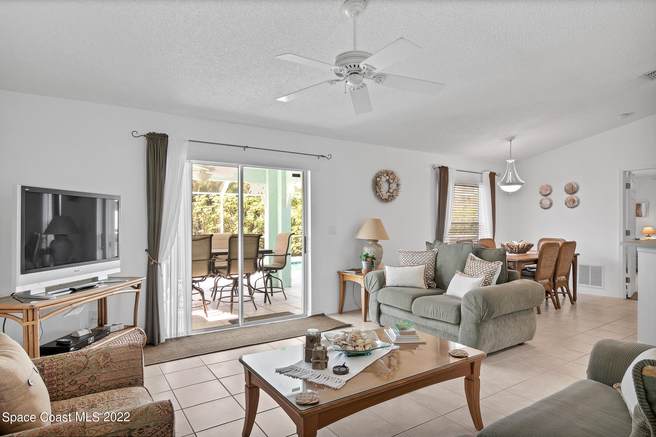382 Benchor Street Sebastian, FL 32958 - Photo 16 of 34 a living room with furniture a flat screen tv and a large window