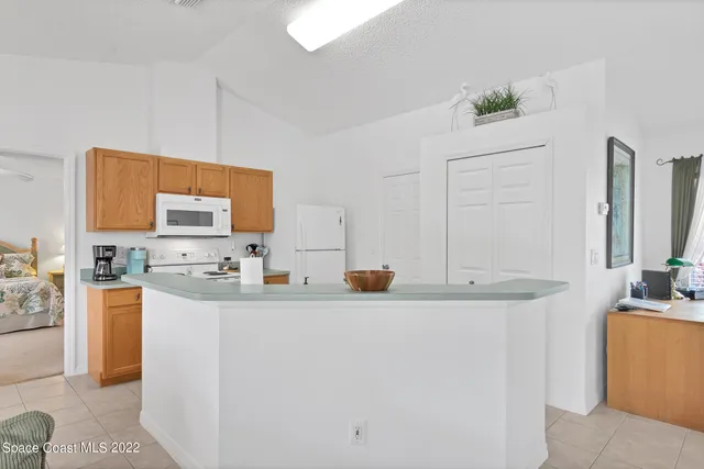a kitchen with a sink a stove and a refrigerator