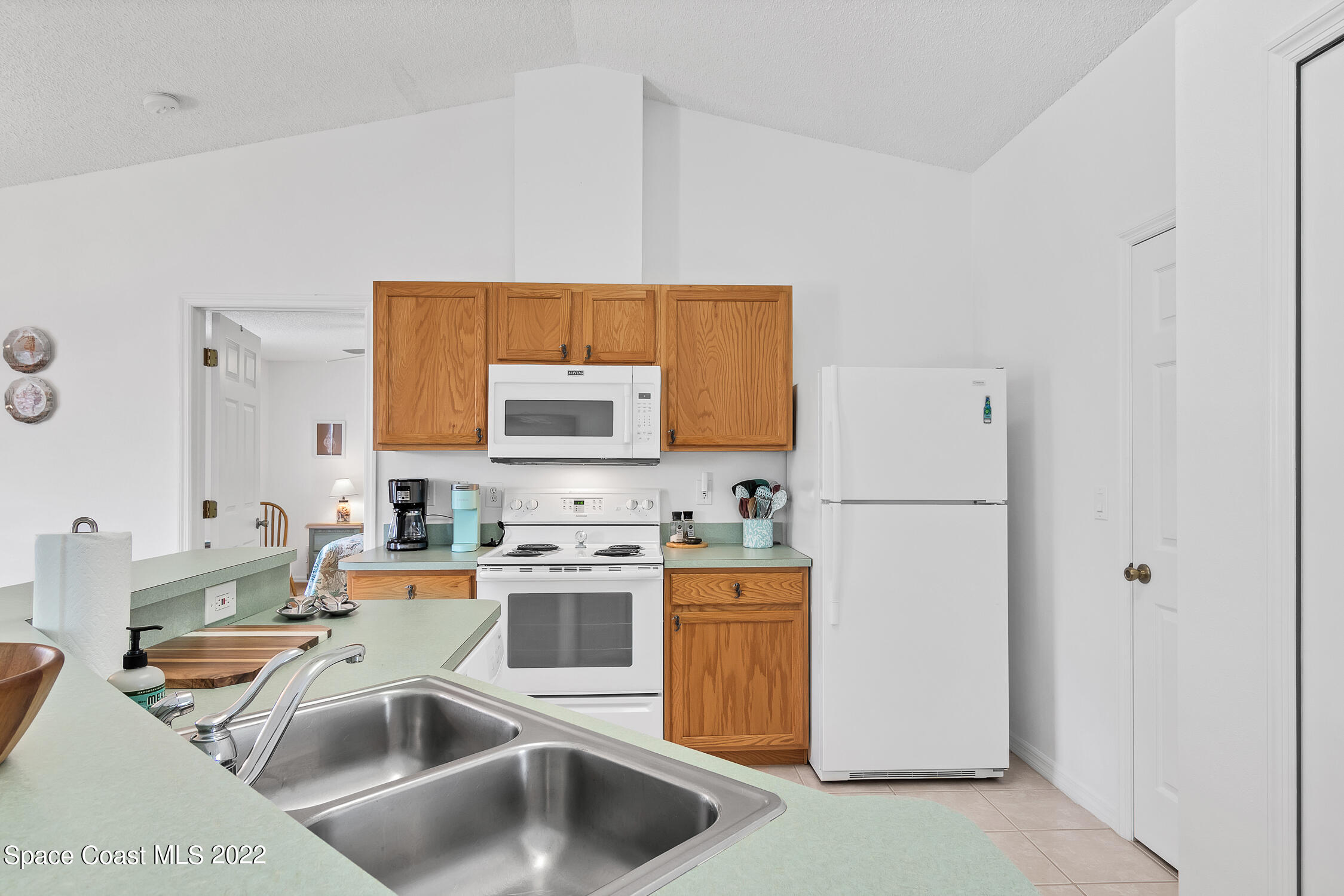 382 Benchor Street Sebastian, FL 32958 - Photo 22 of 34 a kitchen with a sink a stove and a refrigerator