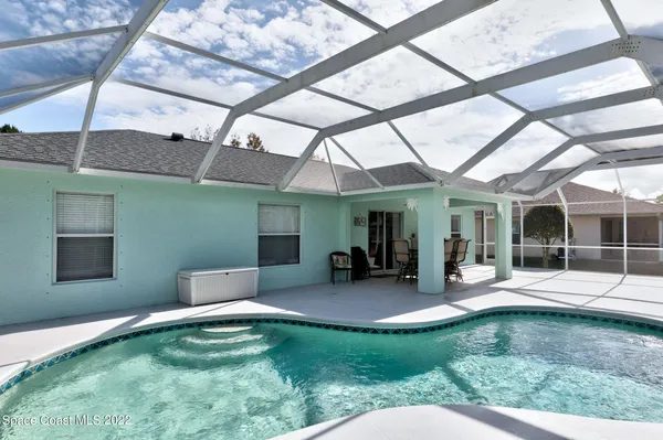 a swimming pool with outdoor seating