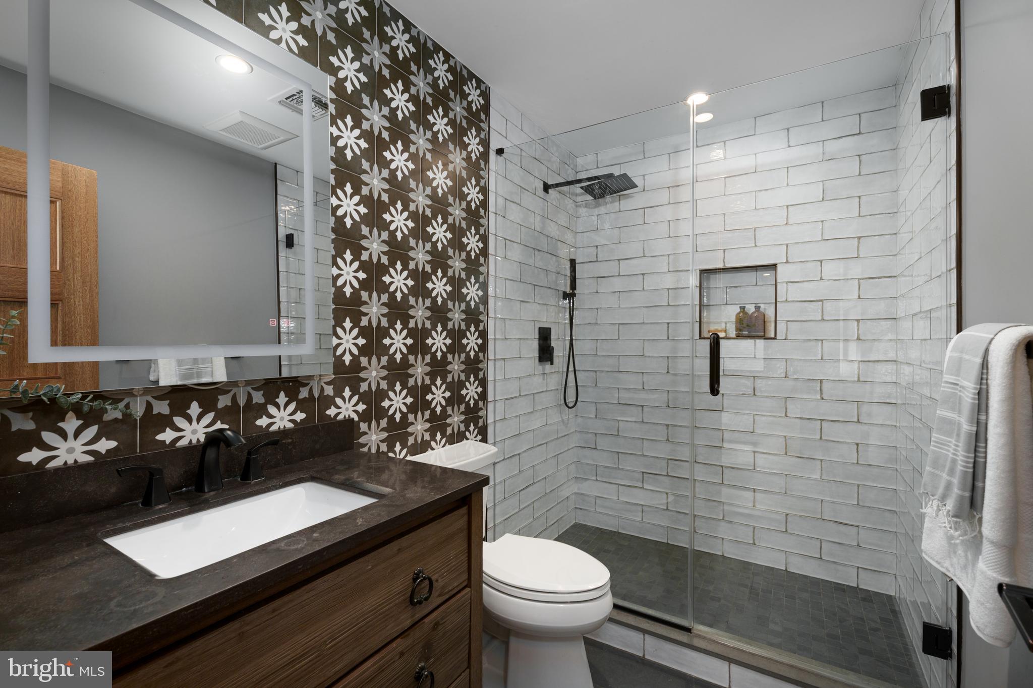 374 Cherry Hill Road Princeton, NJ 08540 - Photo 27 of 42 a bathroom with a granite countertop sink toilet and shower