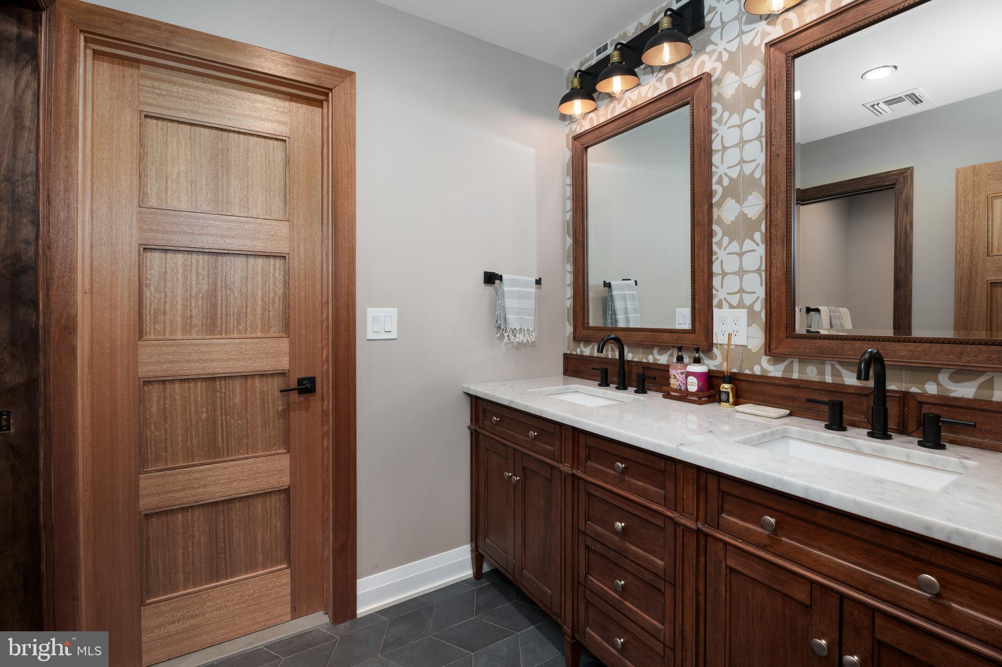 374 Cherry Hill Road Princeton, NJ 08540 - Photo 29 of 42 a bathroom with a double vanity sink and a mirror