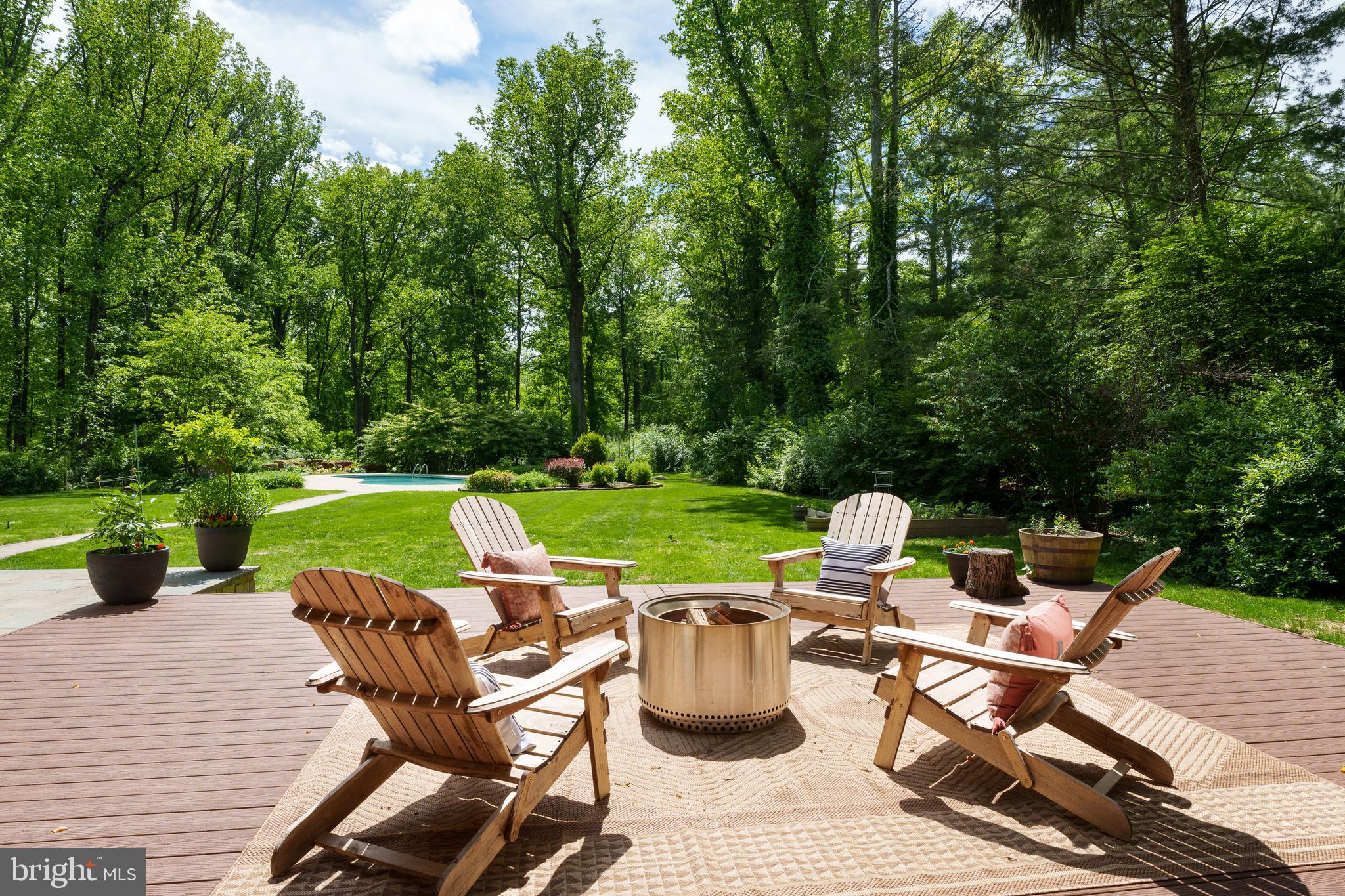 374 Cherry Hill Road Princeton, NJ 08540 - Photo 36 of 42 a view of a patio with table and chairs potted plants with wooden floor and fence