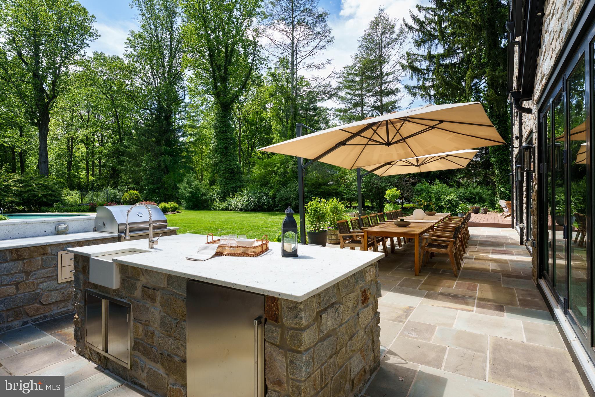 374 Cherry Hill Road Princeton, NJ 08540 - Photo 37 of 42 a view of a patio with chairs and table under an umbrella