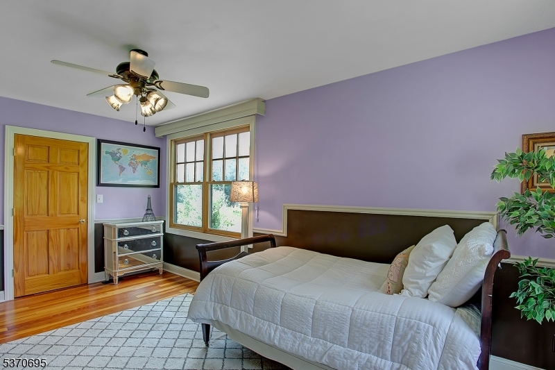 121 Stanton Mountain Road Lebanon, NJ 08833 - Photo 17 of 50 a bedroom with a bed and a chandelier