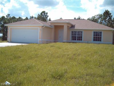 Undisclosed Address Lehigh Acres, FL 33974 - Photo 1 of 7 a view of a house with a yard