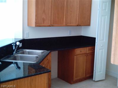 Undisclosed Address Lehigh Acres, FL 33974 - Photo 3 of 7 a kitchen with a sink and cabinets