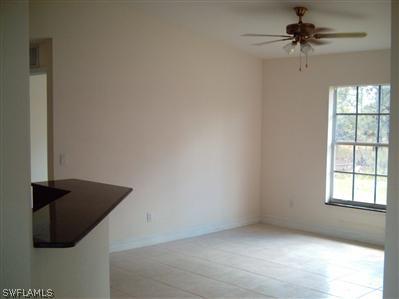 Undisclosed Address Lehigh Acres, FL 33974 - Photo 5 of 7 an empty room with windows and fan