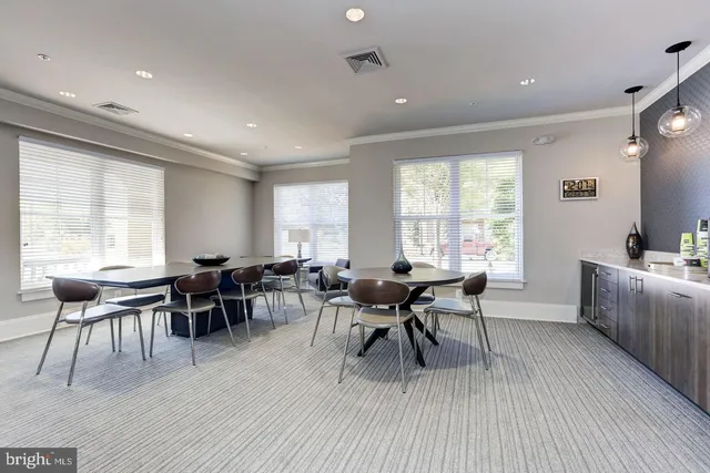 a dining room with furniture and wooden floor