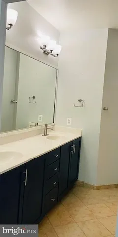 a bathroom with a sink vanity and mirror