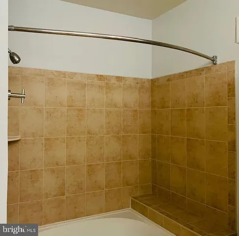 a bathroom with a shower and a shower head