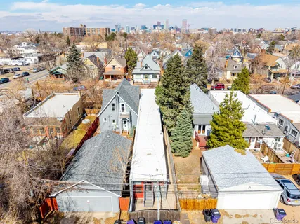 a view of a house with a yard covered in snow
