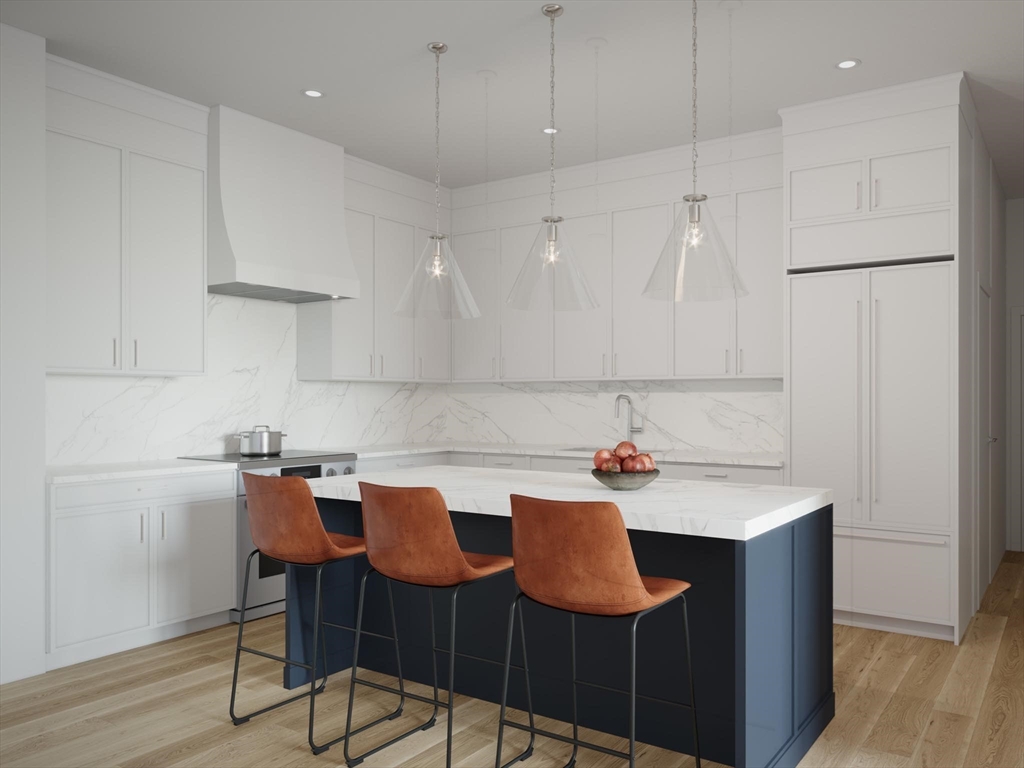 16 Stearns Road, Unit 104 Wellesley, MA 02482 - Photo 4 of 6 a kitchen with stainless steel appliances granite countertop a sink a stove a refrigerator and white cabinets with wooden floor