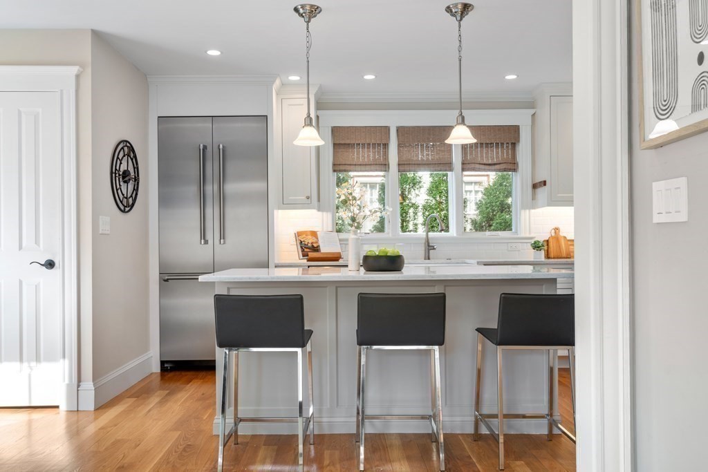 85 Manet Road Newton, MA 02467 - Photo 13 of 40 a kitchen with a table chairs refrigerator and microwave