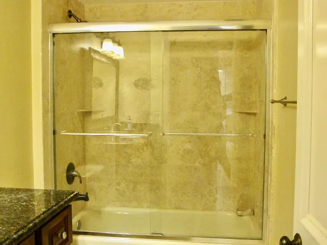 a bathroom with a shower and a sink