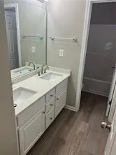a bathroom with a double vanity sink and mirror
