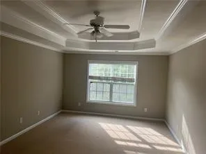 an empty room with a ceiling fan and window