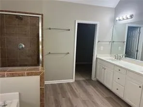 a bathroom with a double vanity sink and mirror