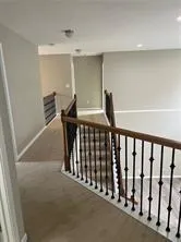 a view of a hallway with seating space