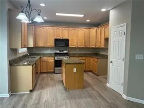 a kitchen with a sink cabinets and window