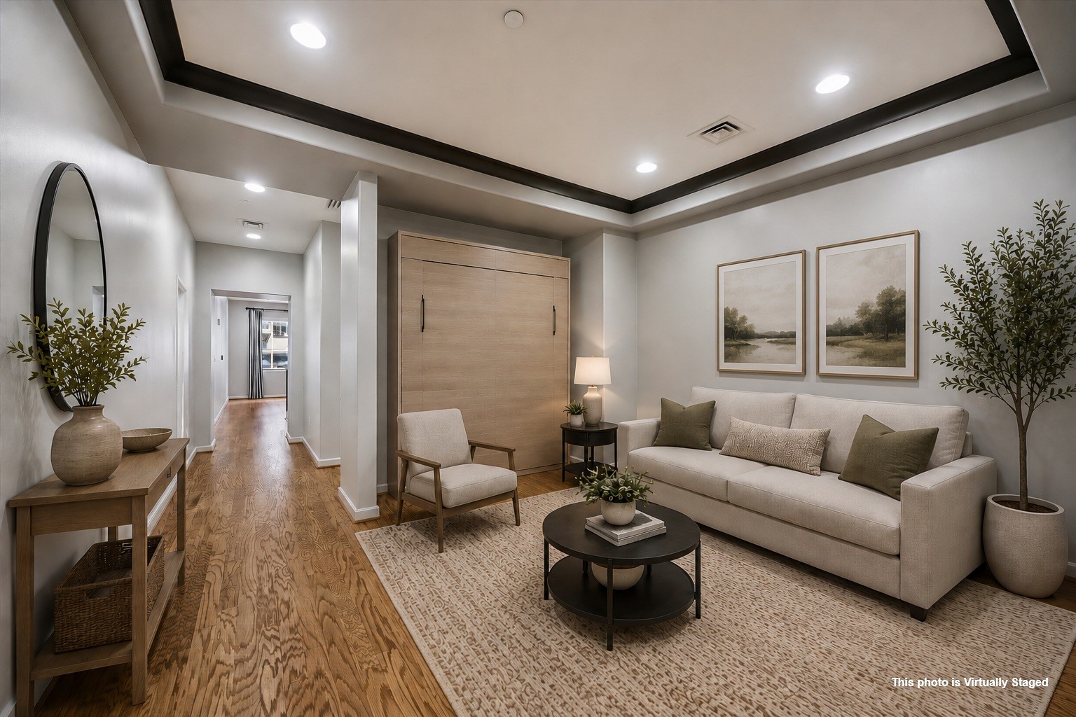 914 Main Street, Unit 910 Houston, TX 77002 - Photo 4 of 32 This virtually staged photo showcases a cozy, entry modern living area with a light color palette. A murphy bed can be added when you have guests.