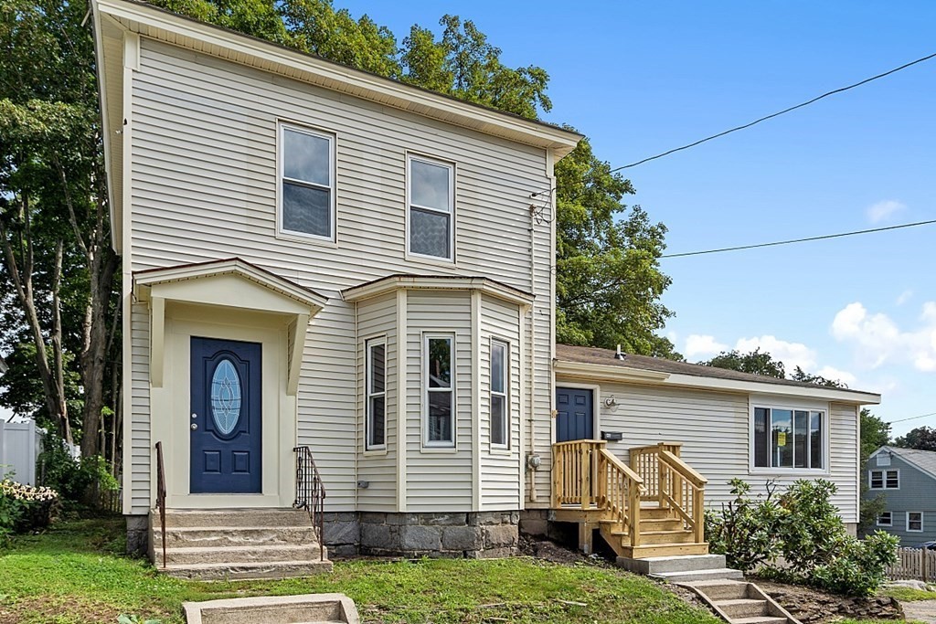 46 West Meadow Road Lowell, MA 01854 - Photo 1 of 42 a front view of a house with garden