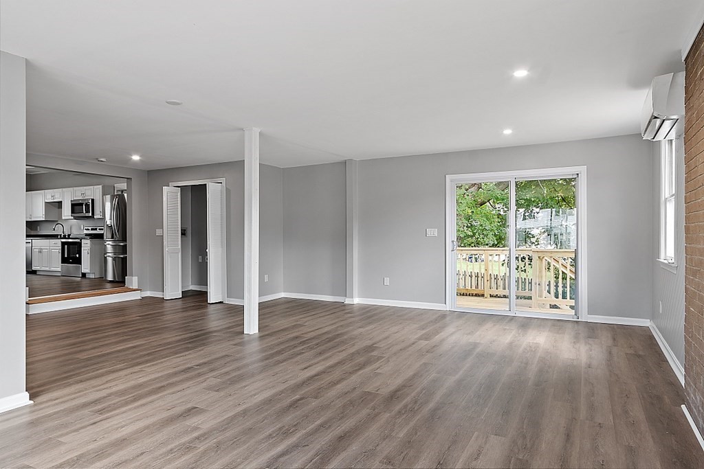 46 West Meadow Road Lowell, MA 01854 - Photo 11 of 42 a view of an empty room with wooden floor and a window